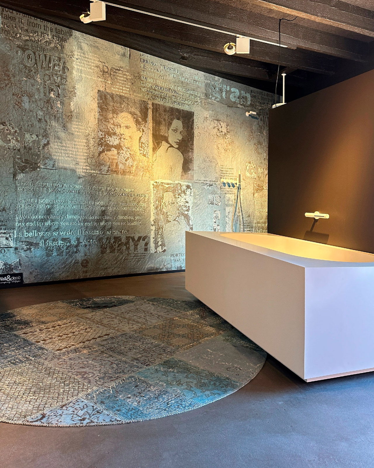 A gray-blue rug that complements the stone surfaces in a contemporary architectural space
