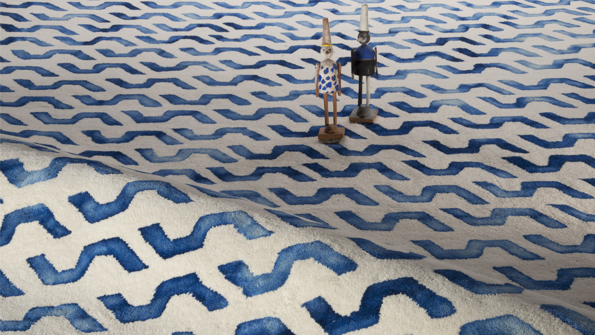 Wool fibers from an indigo-dyed rug, displaying chromatic depth and tonal variations in natural light