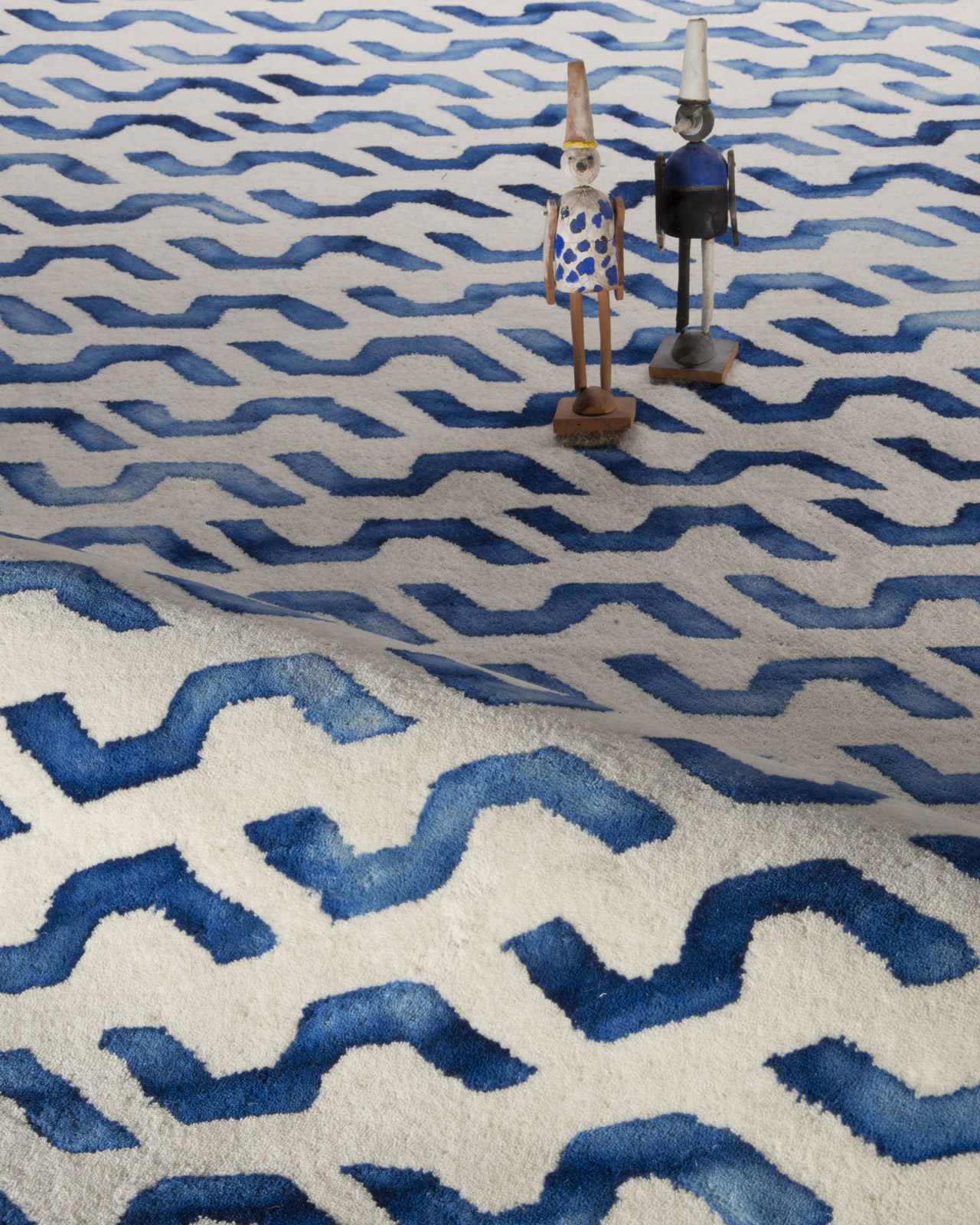 Wool fibers from an indigo-dyed rug, displaying chromatic depth and tonal variations in natural light